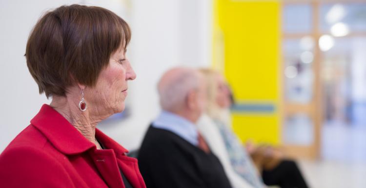 Patients sitting in a hospital waiting room.